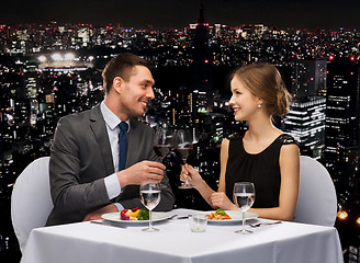 Image showing smiling couple eating main course at restaurant