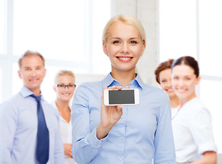 Image showing smiling businesswoman with smartphone blank screen