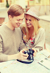 Image showing smiling couple with photo camera