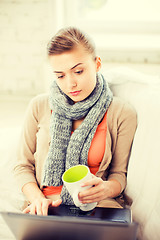 Image showing diseased woman in scarf using laptop at home