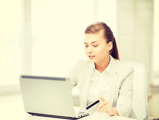 Image showing businesswoman with laptop using credit card