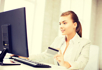 Image showing businesswoman with laptop using credit card