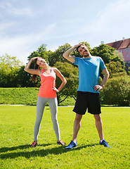 Image showing smiling couple stretching outdoors