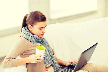 Image showing diseased woman in scarf using laptop at home