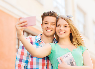 Image showing smiling couple with smartphone in city