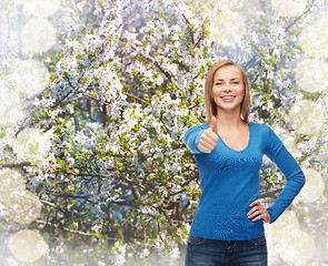 Image showing smiling girl in casual clothes showing thumbs up