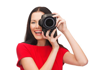 Image showing smiling woman taking picture with digital camera