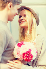 Image showing happy couple with flowers in the city