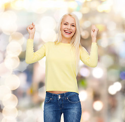 Image showing laughing young woman with hands up