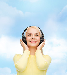 Image showing smiling young woman with headphones