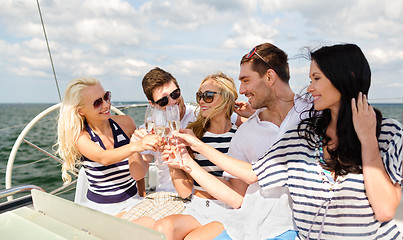 Image showing smiling friends with glasses of champagne on yacht