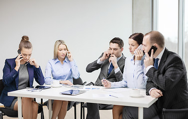 Image showing business team with smartphones having conversation