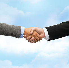 Image showing businessman and businesswoman shaking hands