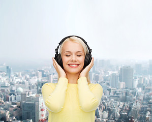 Image showing smiling young woman with headphones