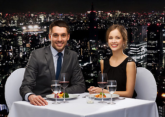 Image showing smiling couple eating main course at restaurant