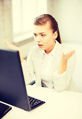 Image showing stressed student with computer in office