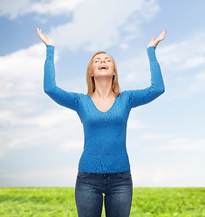 Image showing laughing young woman waving hands