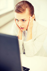 Image showing stressed businesswoman with computer