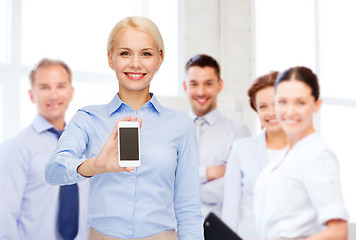 Image showing smiling businesswoman with smartphone blank screen