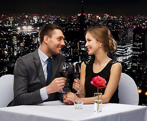 Image showing young couple with glasses of wine at restaurant