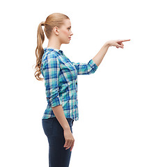 Image showing young woman pressing imaginary button