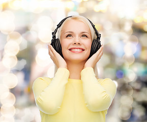 Image showing smiling young woman with headphones