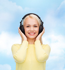 Image showing smiling young woman with headphones