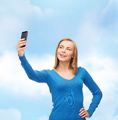 Image showing woman taking self picture with smartphone camera