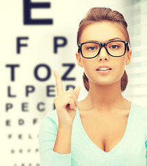 Image showing woman in eyeglasses with eye chart