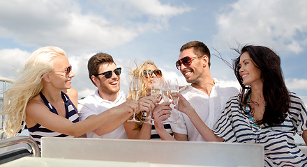 Image showing smiling friends with glasses of champagne on yacht