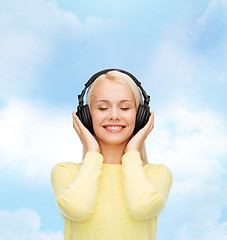 Image showing smiling young woman with headphones