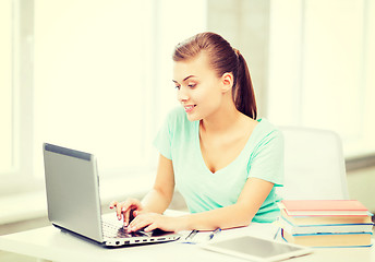 Image showing smiling student girl with laptop