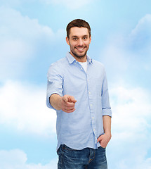 Image showing smiling man pointing finger at you