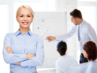 Image showing young smiling businesswoman with crossed arms