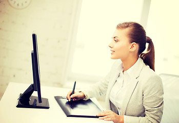 Image showing businesswoman with drawing tablet in office