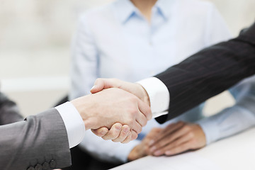 Image showing two businessmen shaking hands in office