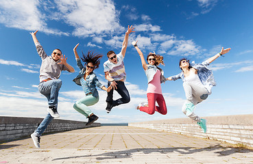 Image showing group of teenagers jumping