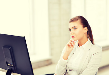 Image showing pensive woman in office