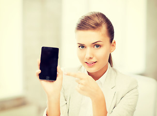 Image showing businesswoman with smartphone in office