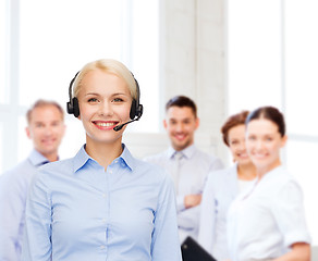 Image showing friendly female helpline operator with headphones