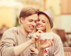 Image showing couple taking selfie with smartphone