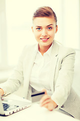 Image showing businesswoman with laptop using credit card