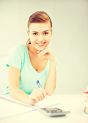 Image showing student girl with notebook and calculator