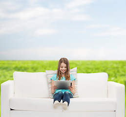 Image showing little girl sitting on sofa with tablet pc