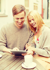 Image showing couple looking at tablet pc in cafe