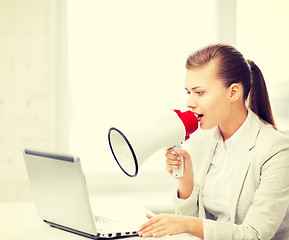 Image showing strict businesswoman shouting in megaphone