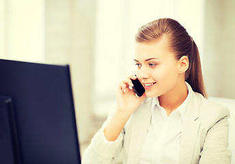 Image showing businesswoman with smartphone in office