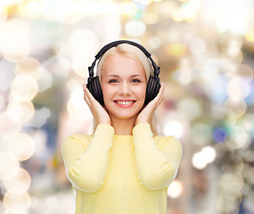 Image showing smiling young woman with headphones