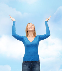 Image showing laughing young woman waving hands