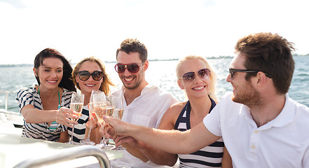 Image showing smiling friends with glasses of champagne on yacht